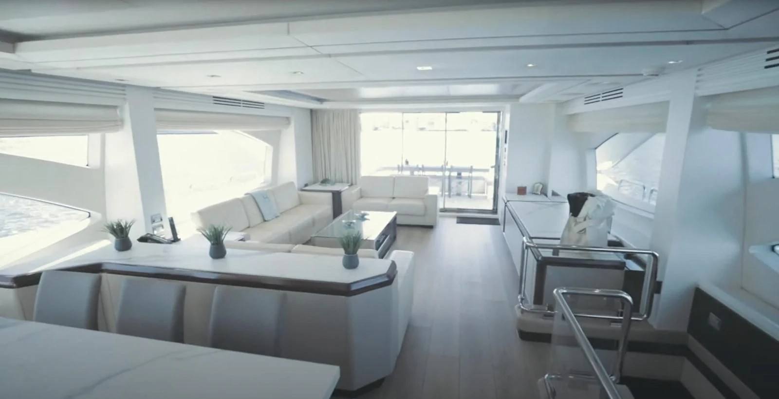 a large room with white furniture aboard BT2 Yacht for Sale