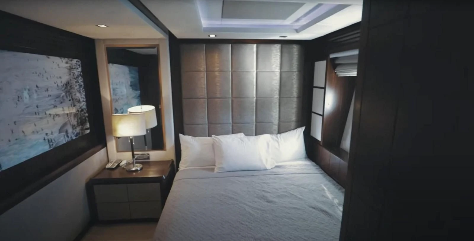 a room with a bed and a lamp aboard BT2 Yacht for Sale