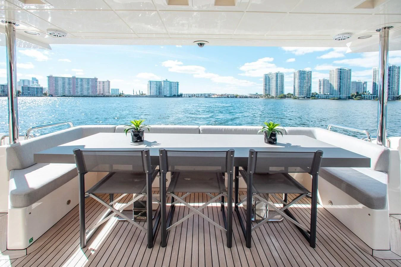 a table and chairs on a balcony overlooking a city aboard BT2 Yacht for Sale