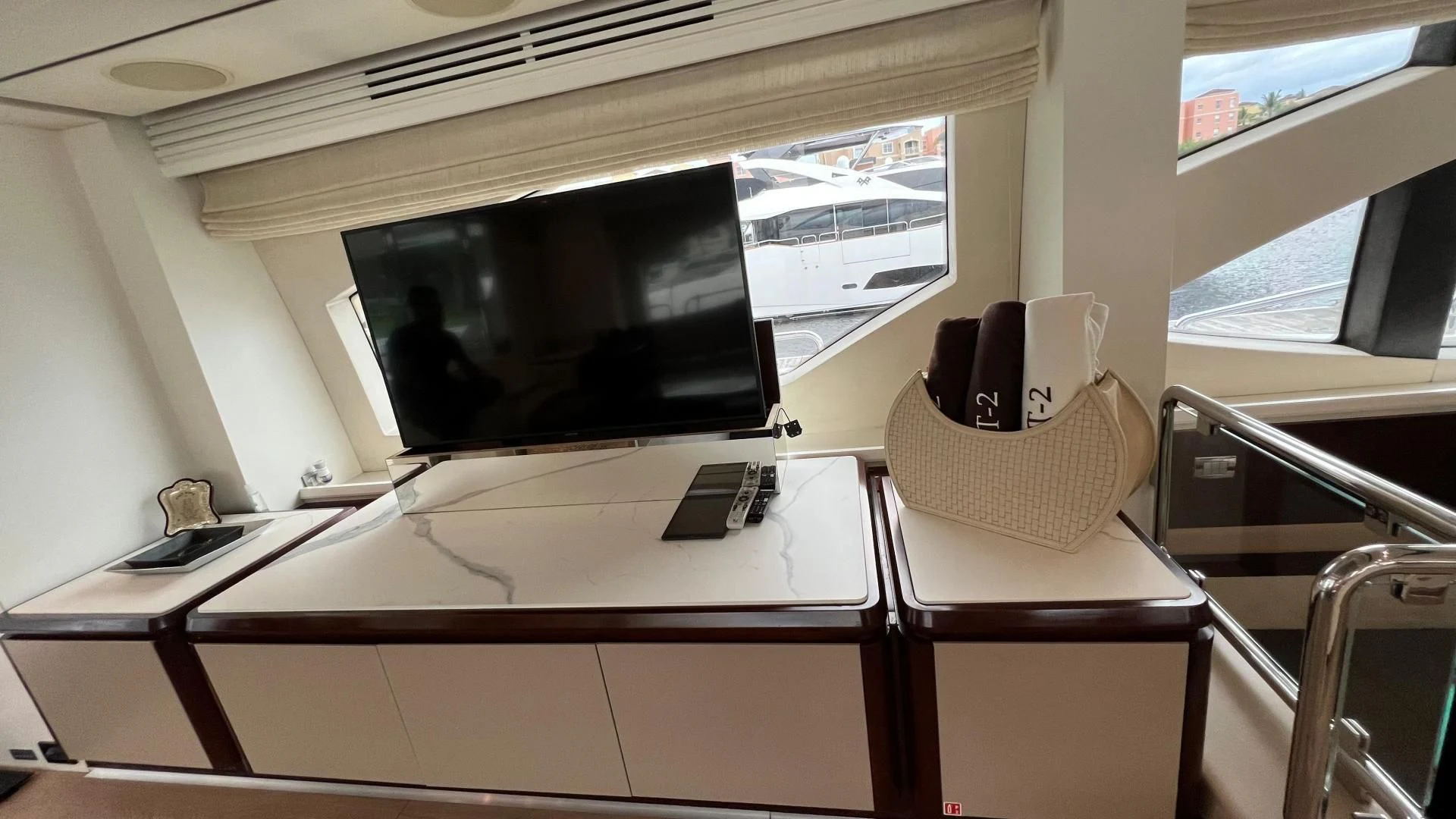 a desk with a computer and a hat on it aboard BT2 Yacht for Sale