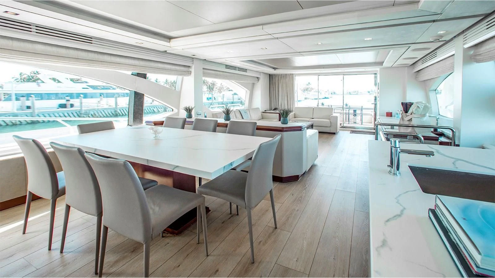 a large room with a table and chairs aboard BT2 Yacht for Sale