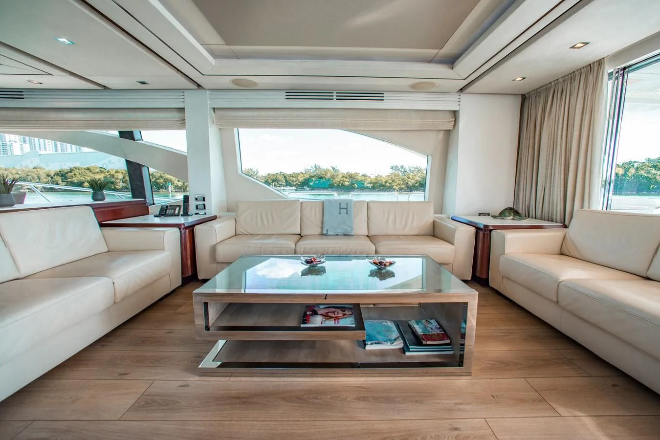 a living room with a table and couches aboard BT2 Yacht for Sale