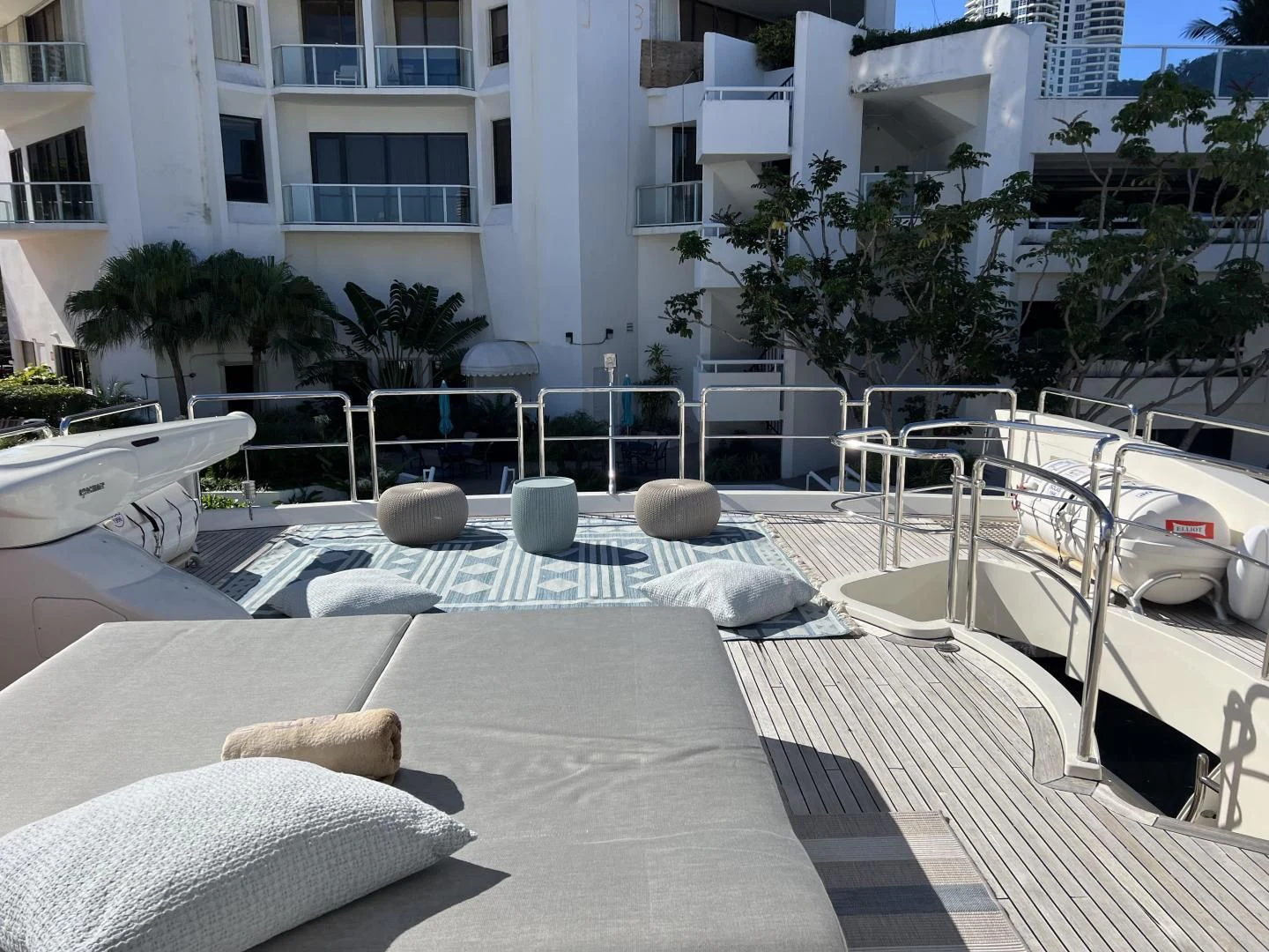 a patio with a pool and a building with trees and plants aboard BT2 Yacht for Sale