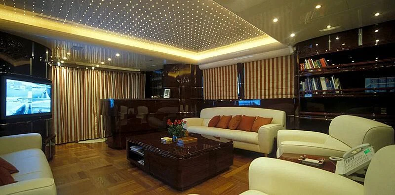 a living room with a large screen aboard CONTESSINA Yacht for Sale