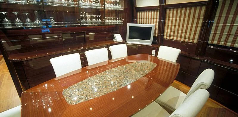 a room with a tv and chairs aboard CONTESSINA Yacht for Sale