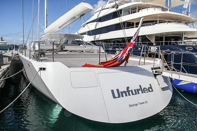 a boat docked at a pier aboard UNFURLED Yacht for Sale