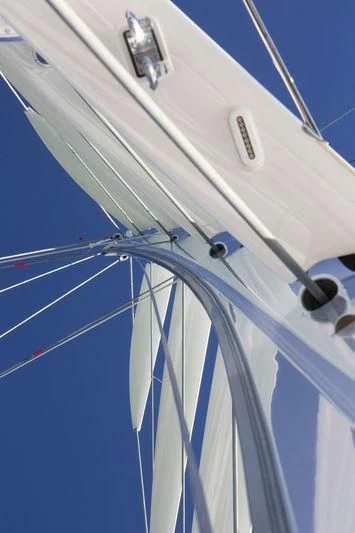 a white boat with ropes aboard UNFURLED Yacht for Sale