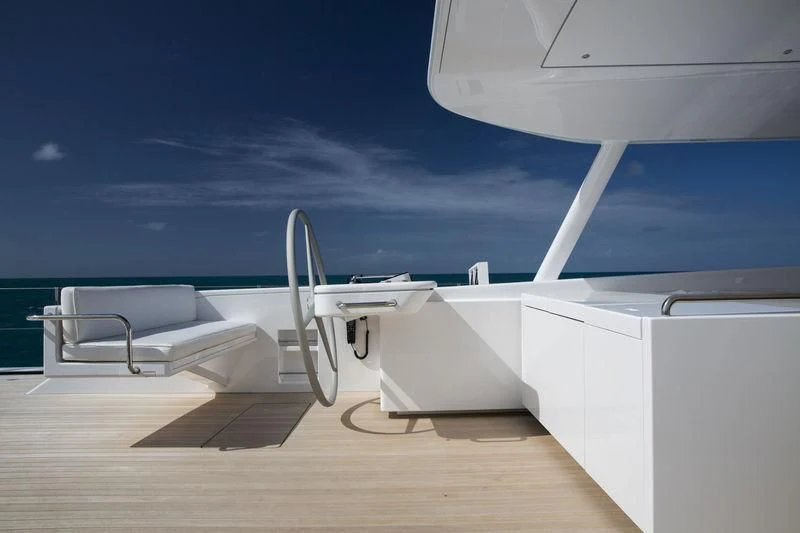 a deck with a chair and a desk aboard UNFURLED Yacht for Sale