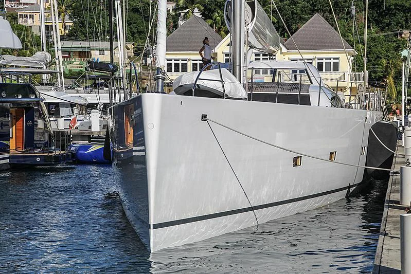 a white boat in a harbor aboard UNFURLED Yacht for Sale