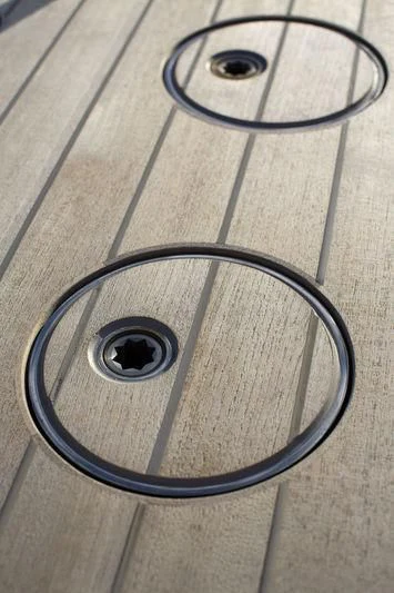 a pair of black sunglasses on a wooden surface aboard UNFURLED Yacht for Sale