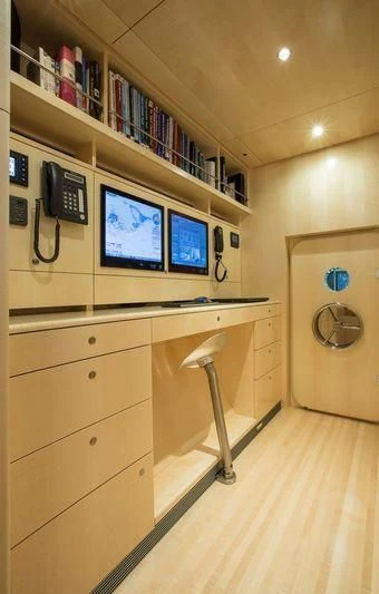 a room with a desk and computer aboard UNFURLED Yacht for Sale