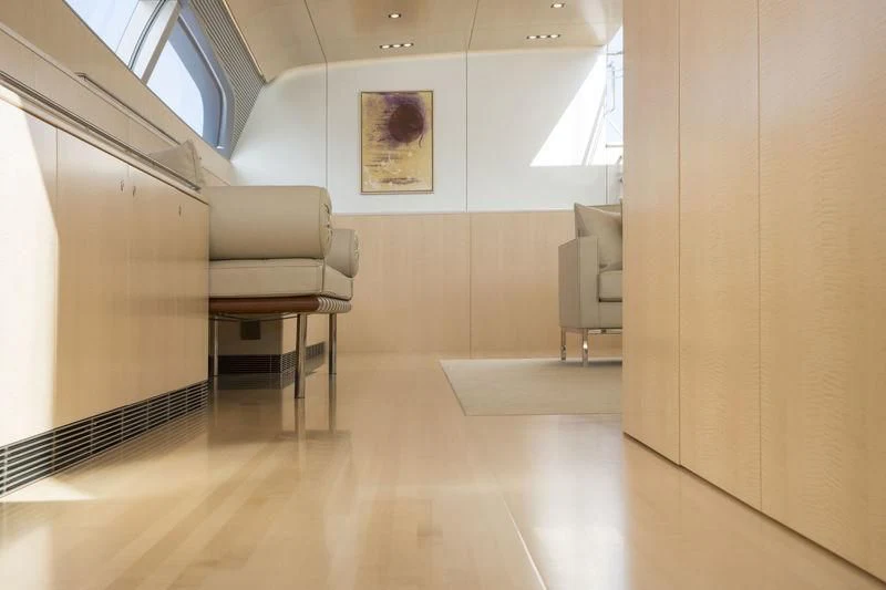 a room with a chair and a table aboard UNFURLED Yacht for Sale