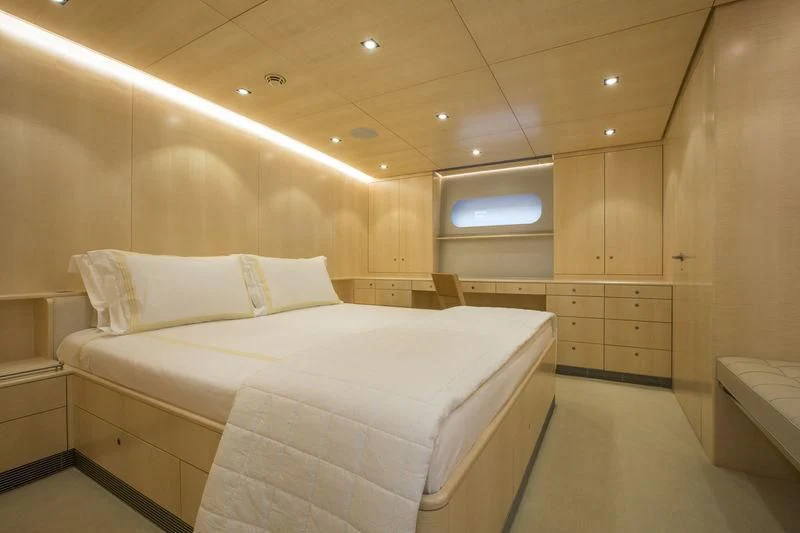 a room with a bed and a window aboard UNFURLED Yacht for Sale