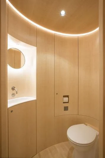 a bathroom with a toilet and a sink aboard UNFURLED Yacht for Sale