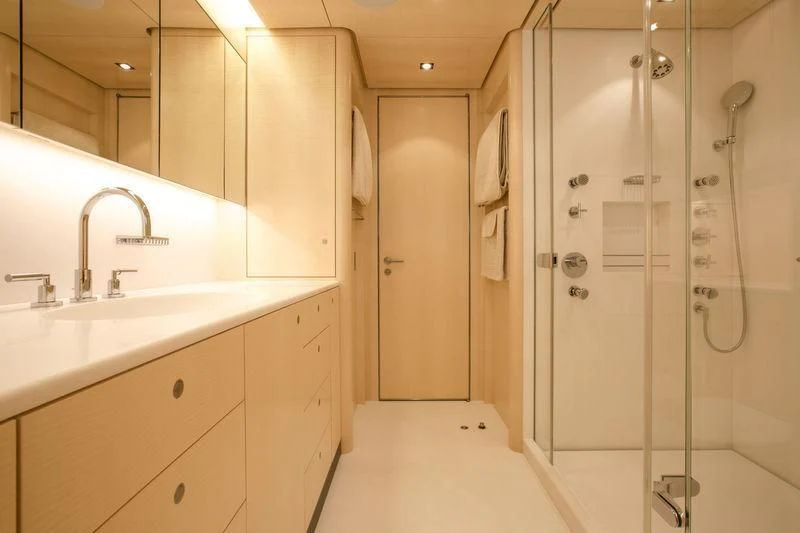 a bathroom with a shower unit and sink aboard UNFURLED Yacht for Sale