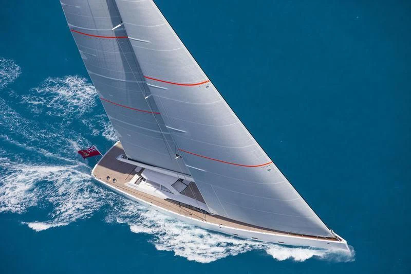 a white and red sailboat in the ocean aboard UNFURLED Yacht for Sale