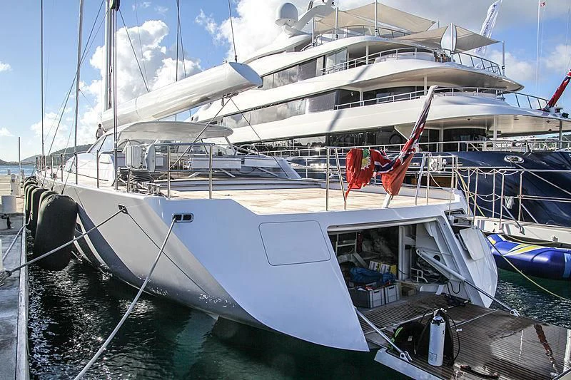 a boat docked at a pier aboard UNFURLED Yacht for Sale