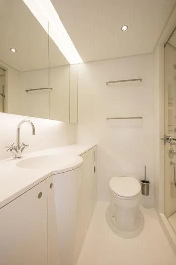 a bathroom with a toilet and sink aboard UNFURLED Yacht for Sale