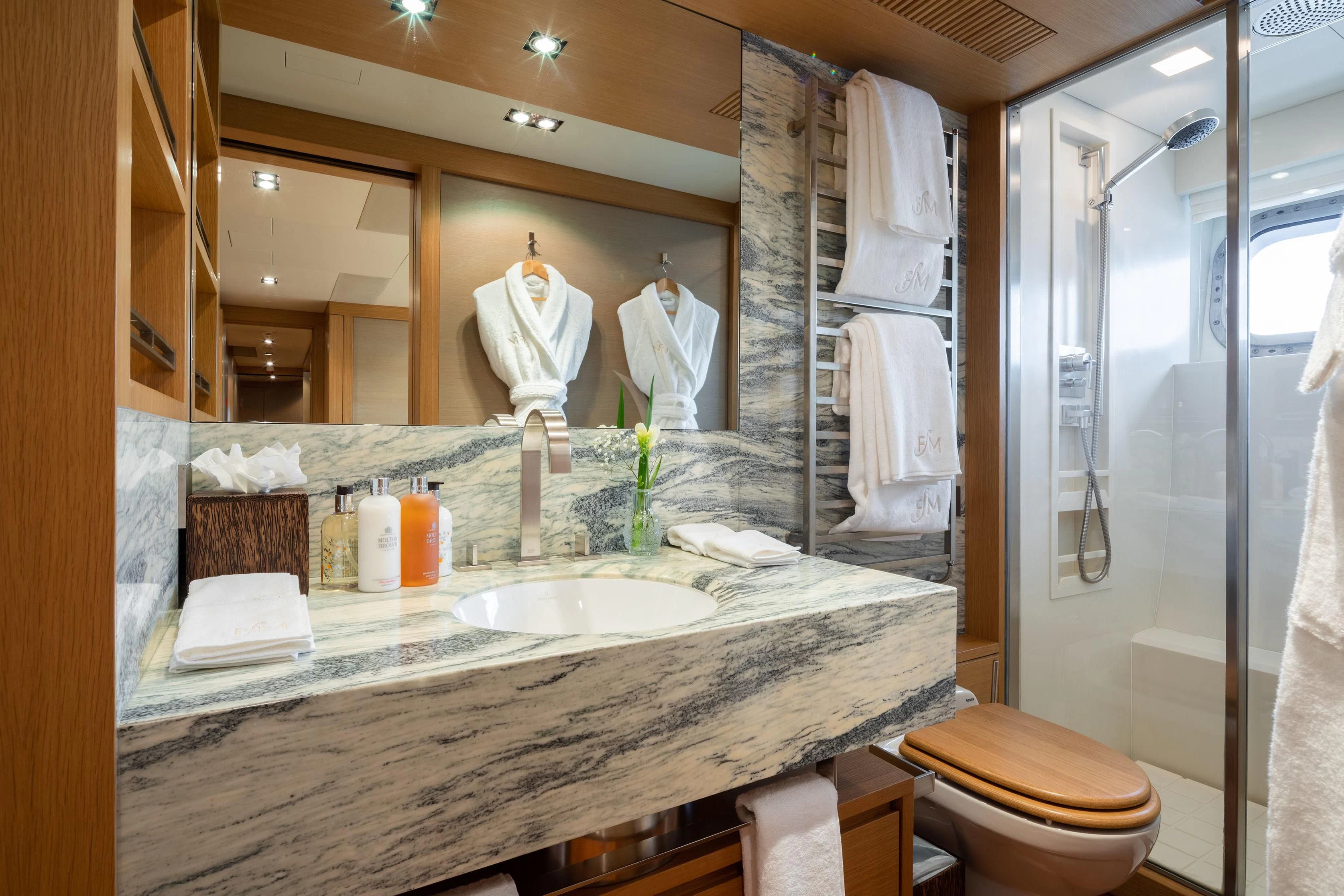 a bathroom with a large mirror aboard FALCO MOSCATA Yacht for Sale