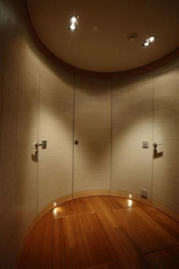 a room with a wood floor and a large wall with a light aboard FALCO MOSCATA Yacht for Sale