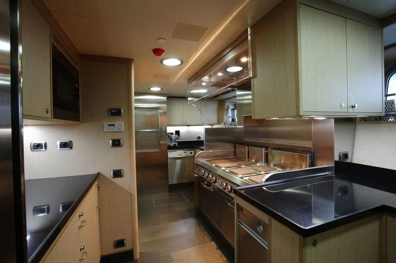 a kitchen with a stove and cabinets aboard FALCO MOSCATA Yacht for Sale
