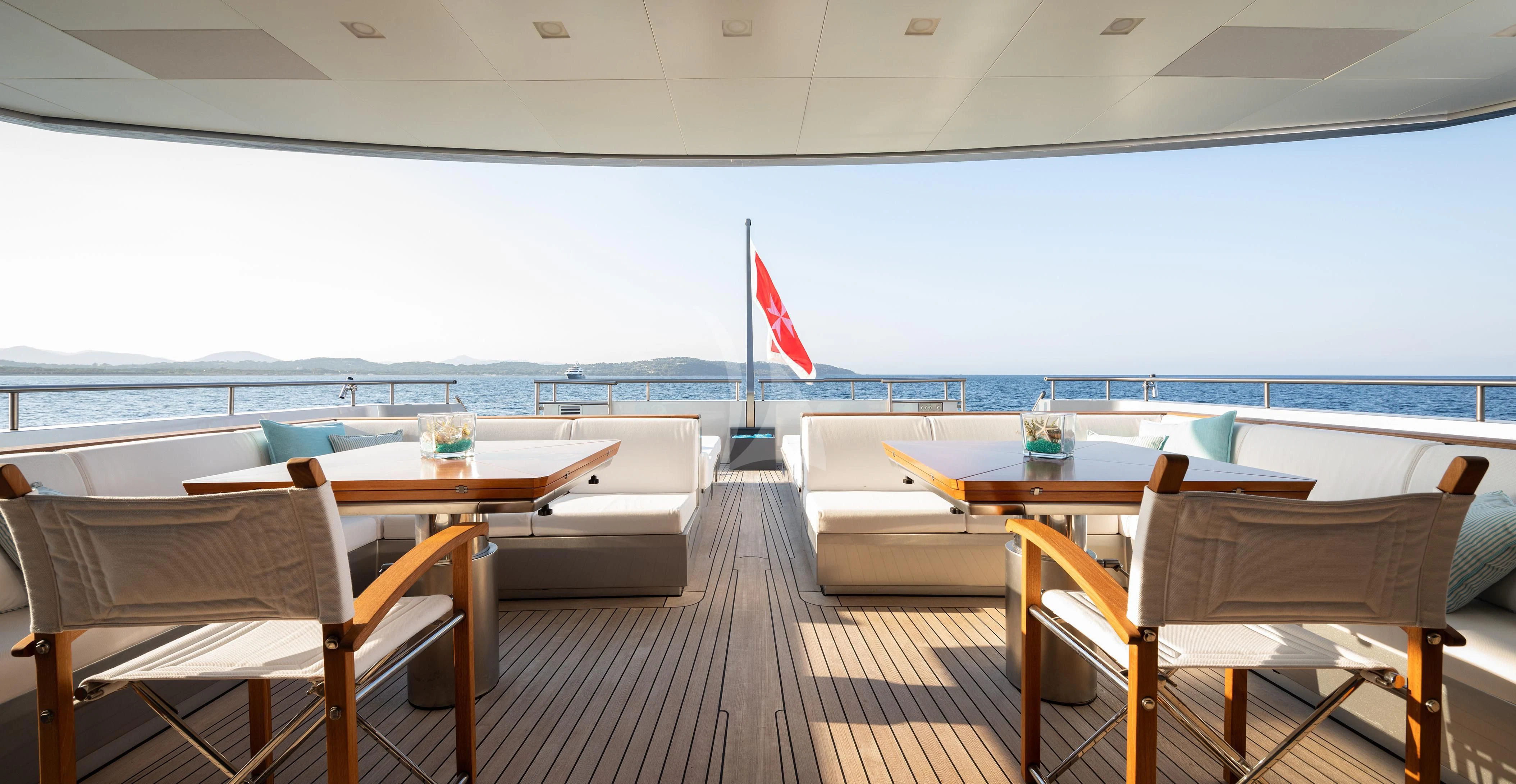 a room with tables and chairs aboard FALCO MOSCATA Yacht for Sale