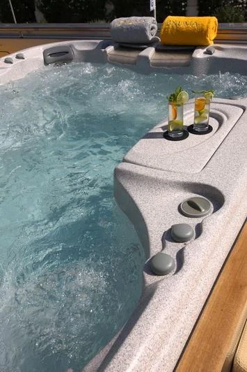 a pool with a table and a couple of objects on it aboard FALCO MOSCATA Yacht for Sale