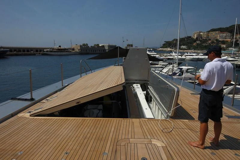 a man standing on a dock looking at boats in the water aboard FALCO MOSCATA Yacht for Sale