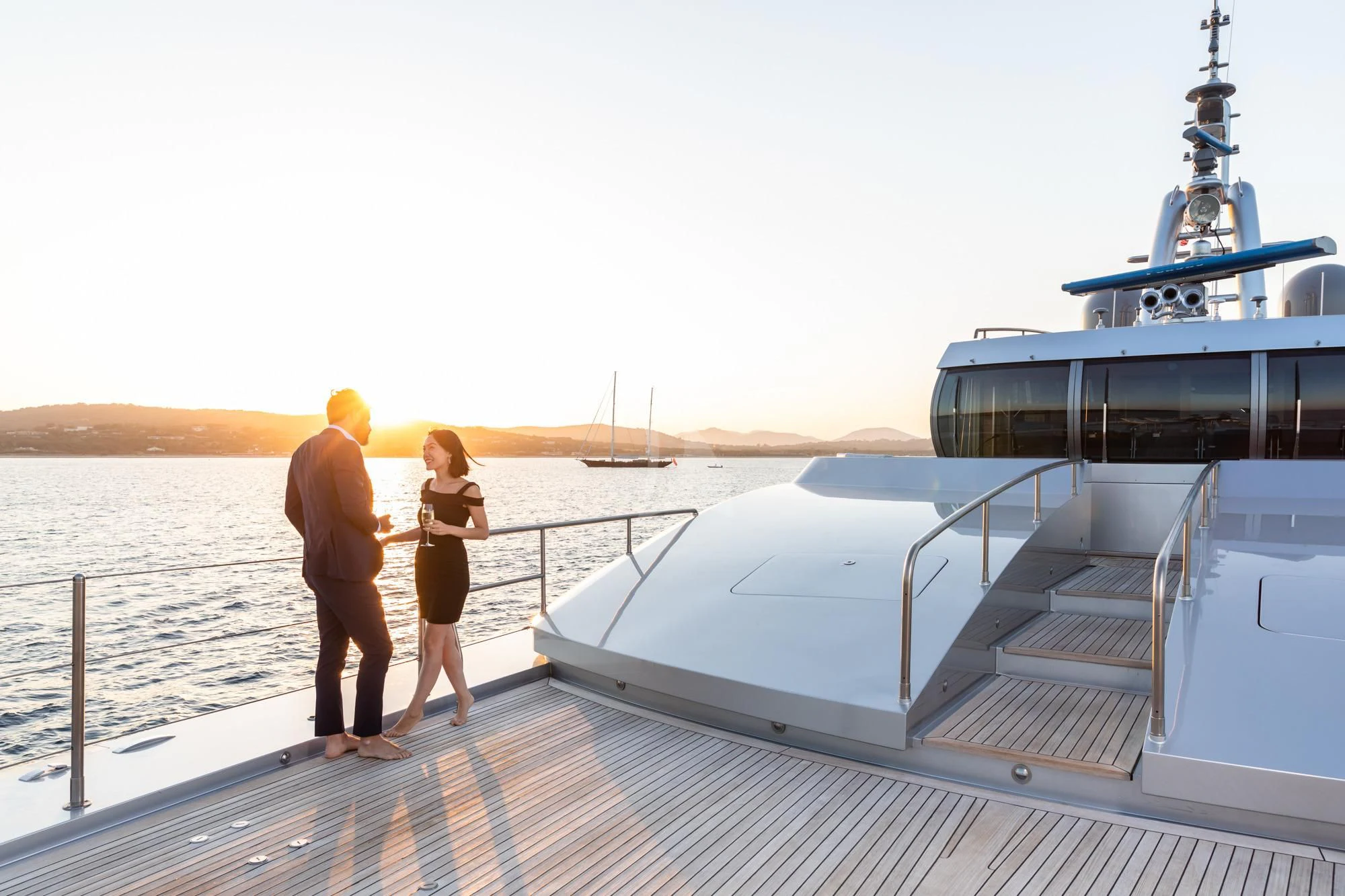 a man and woman standing on a dock looking at a boat aboard FALCO MOSCATA Yacht for Sale
