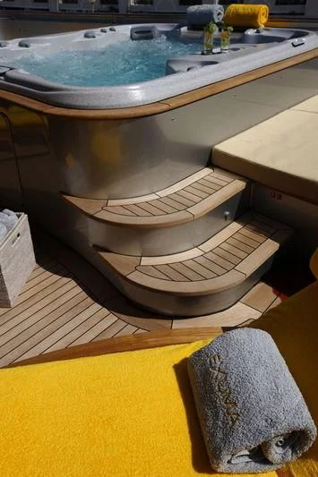 a large round tub with a wooden seat and a wooden surface aboard FALCO MOSCATA Yacht for Sale