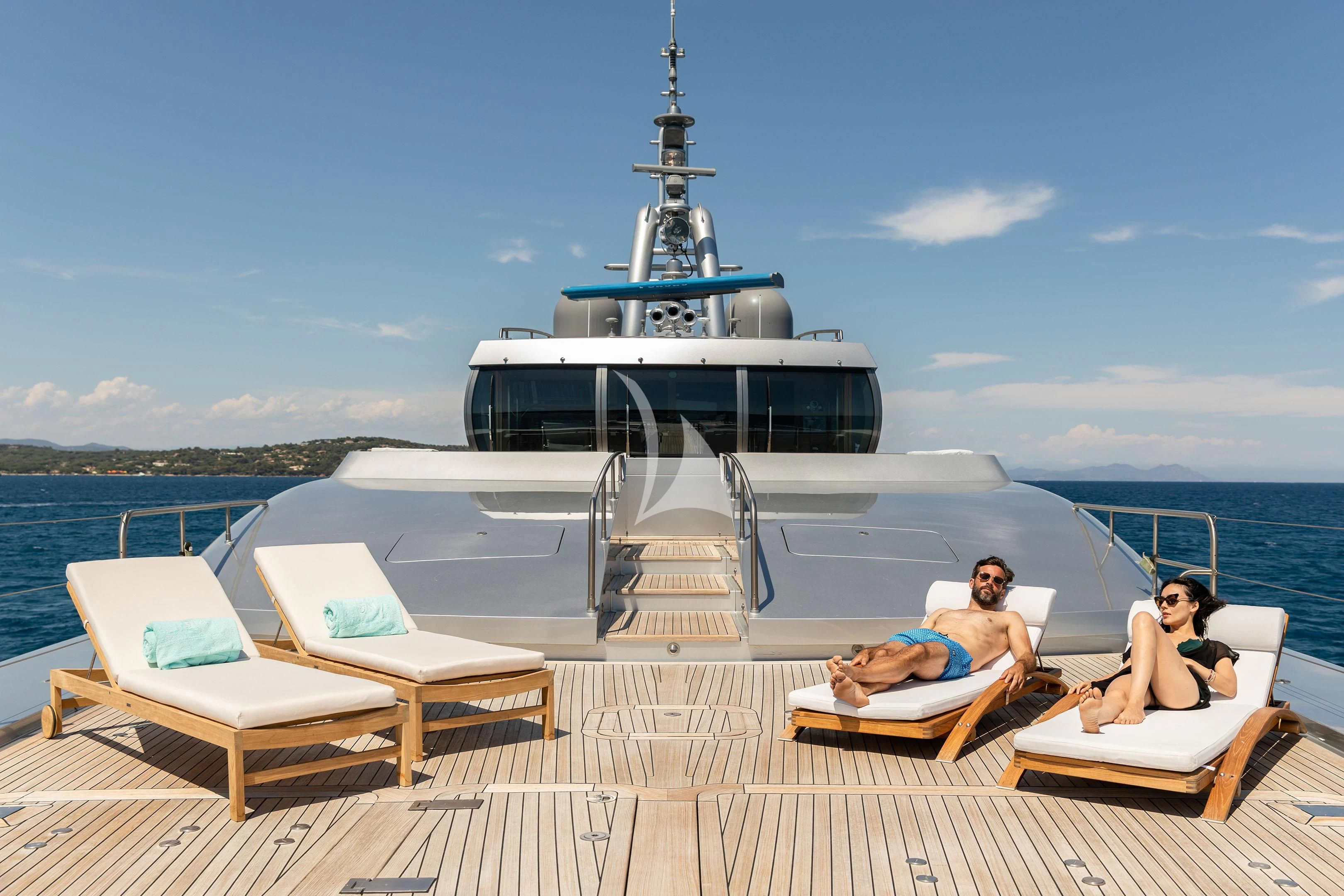 a couple of people sitting on a lounge chair on a boat aboard FALCO MOSCATA Yacht for Sale