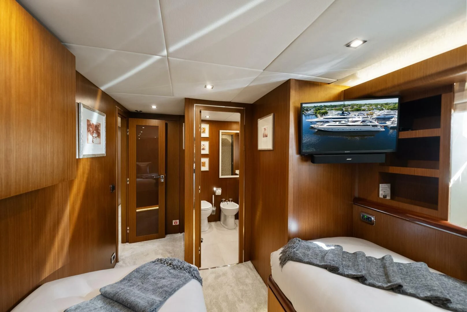 a bedroom with a tv on the wall aboard PRINCESS LONA Yacht for Sale