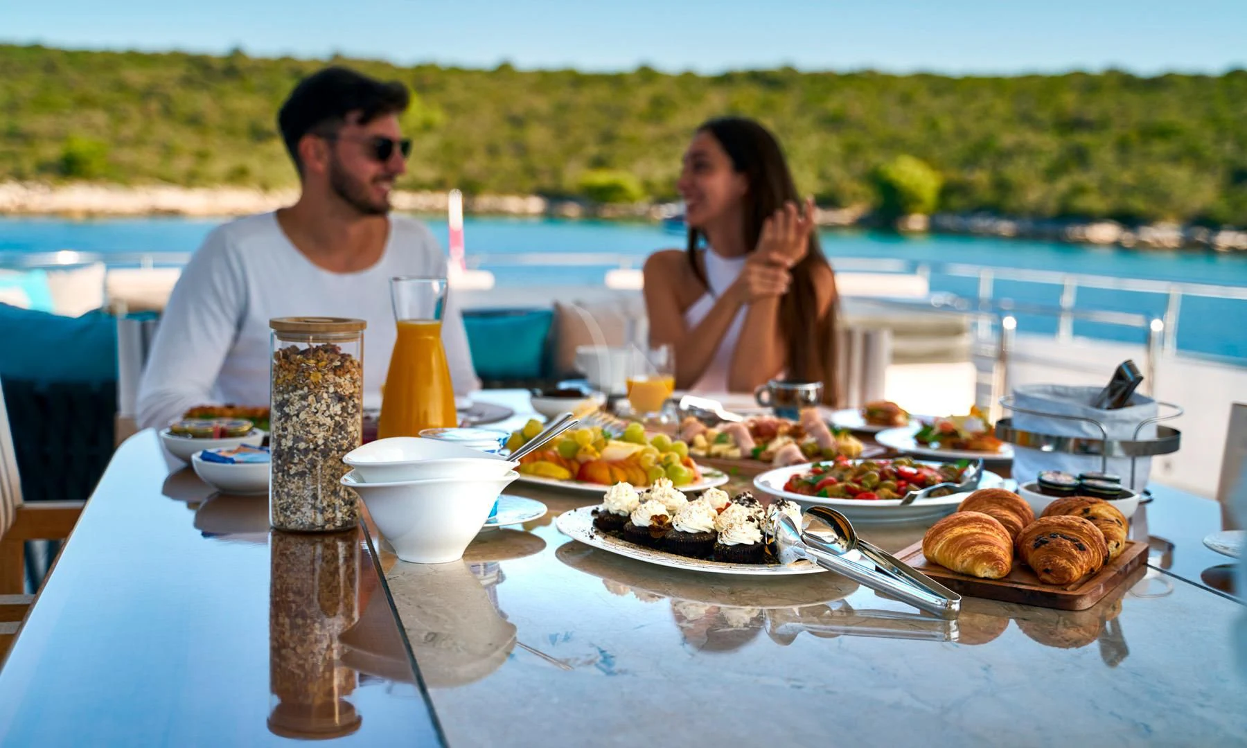 a man and woman eating at a table with food on it aboard PRINCESS LONA Yacht for Sale