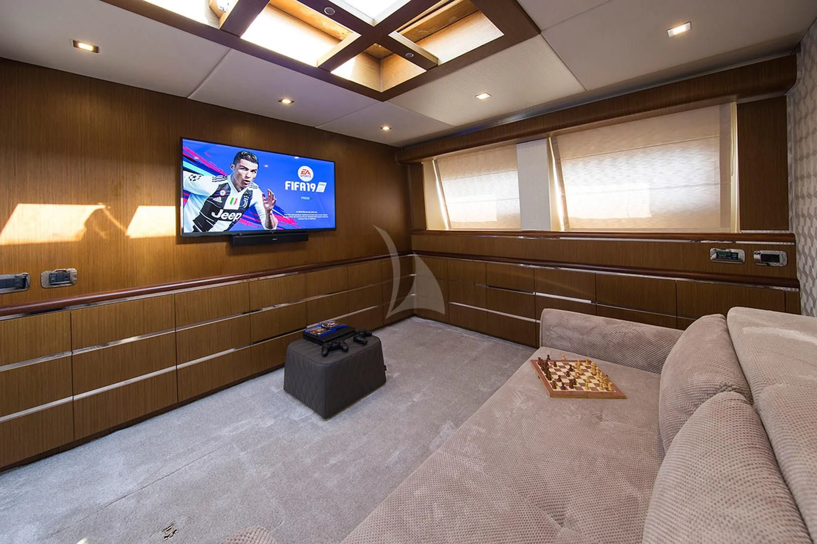 a large living room with a large screen aboard PRINCESS LONA Yacht for Sale