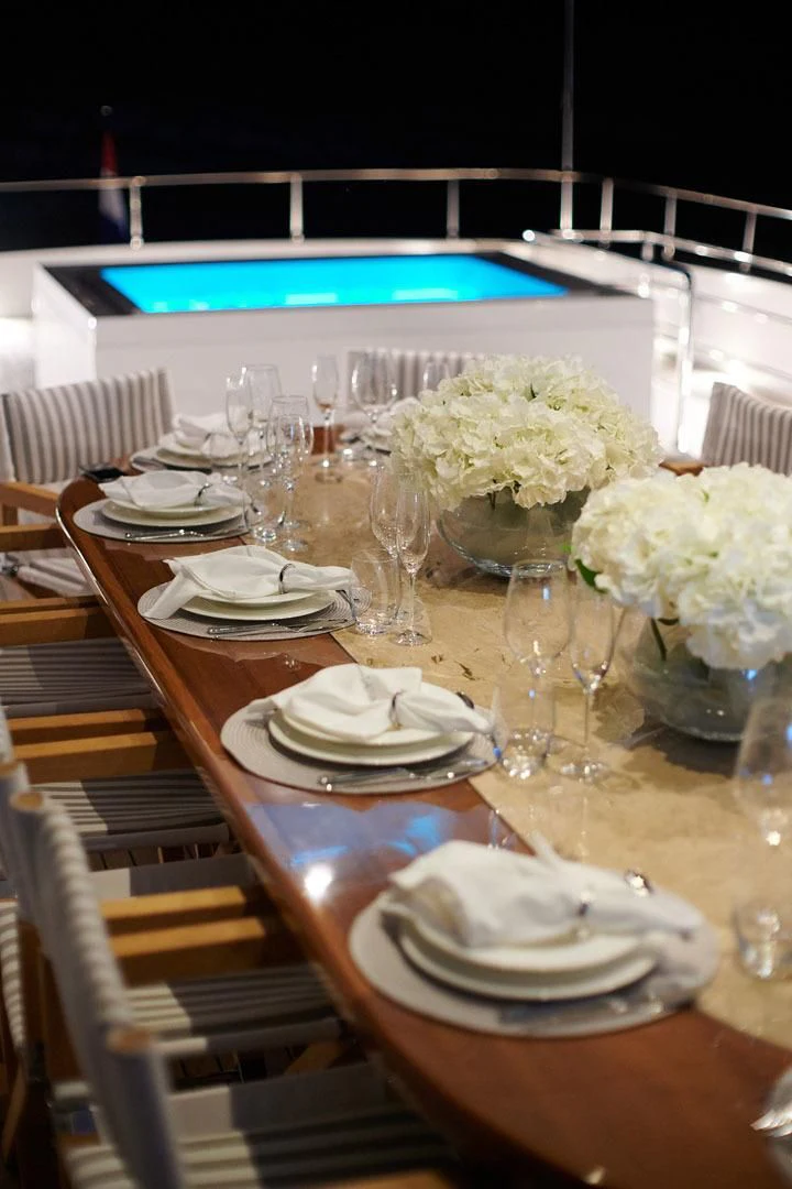 a table with plates and glasses aboard PRINCESS LONA Yacht for Sale
