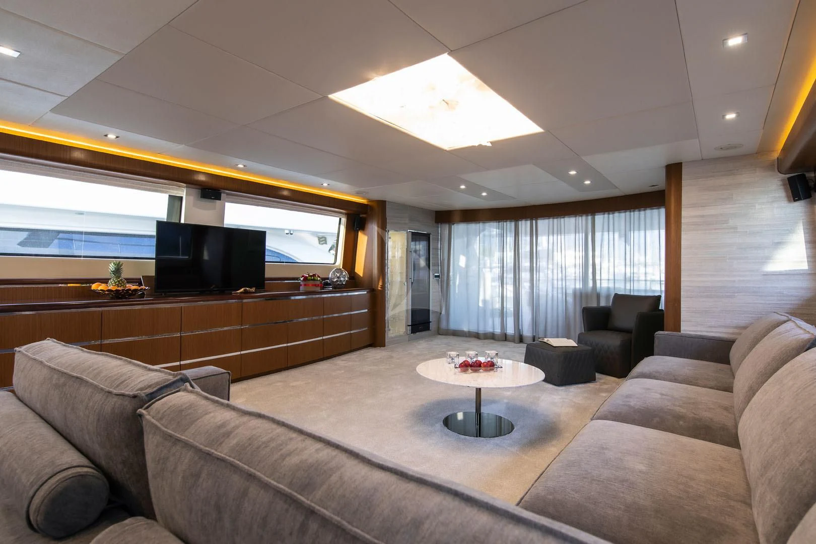 a living room with a couch and a tv aboard PRINCESS LONA Yacht for Sale