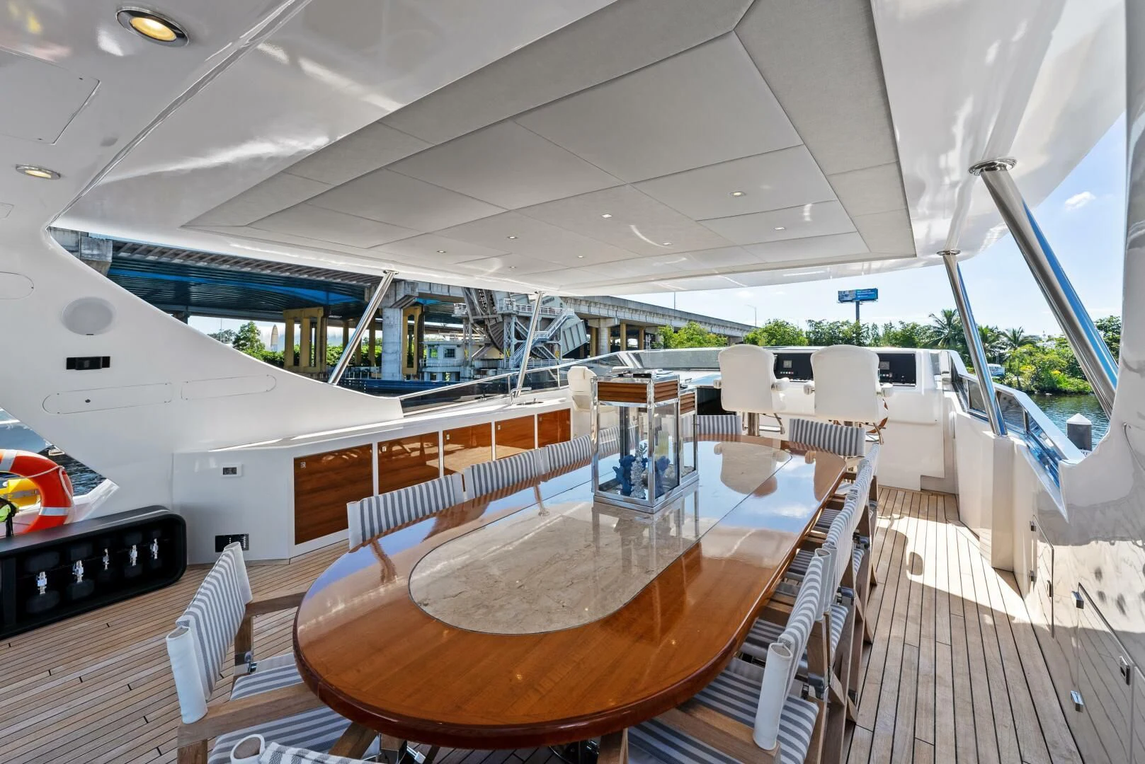 a deck with a table and chairs on it aboard PRINCESS LONA Yacht for Sale