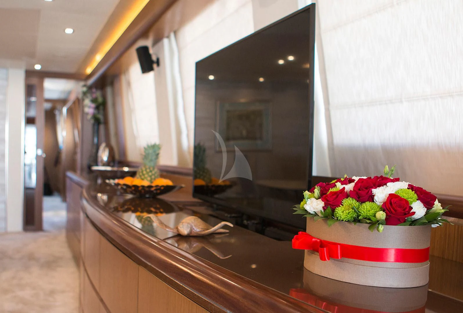 a table with a cake and flowers aboard PRINCESS LONA Yacht for Sale