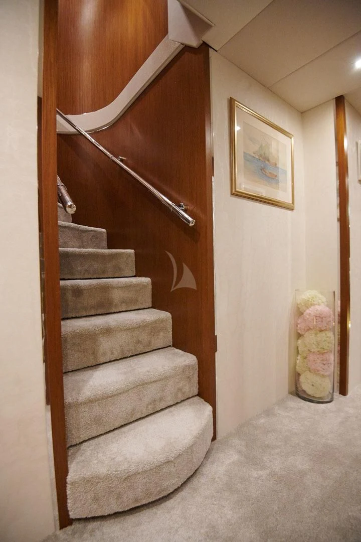 a staircase with a wood railing aboard PRINCESS LONA Yacht for Sale