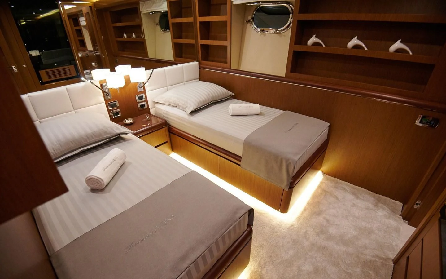 a room with beds and a mirror aboard PRINCESS LONA Yacht for Sale