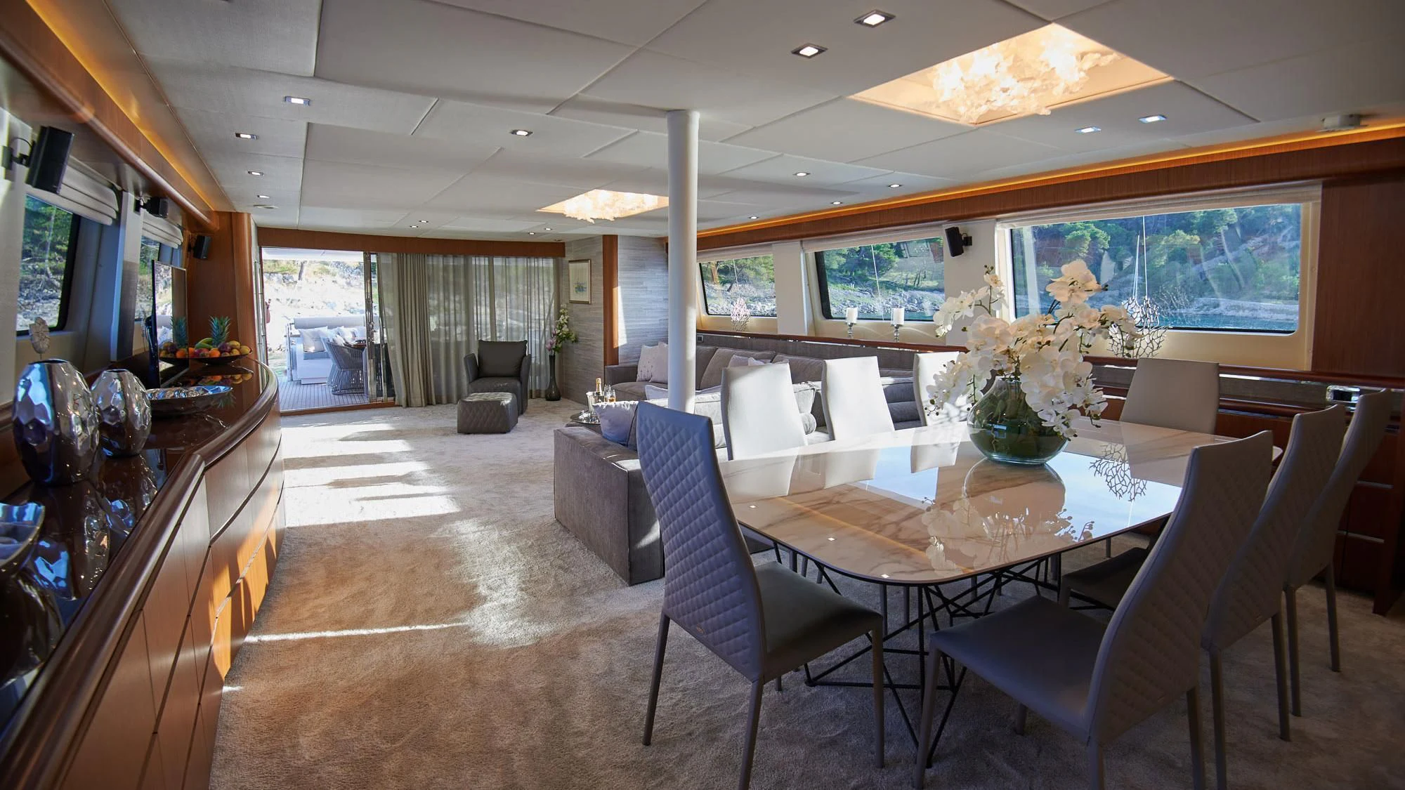 a room with a table chairs and a television aboard PRINCESS LONA Yacht for Sale