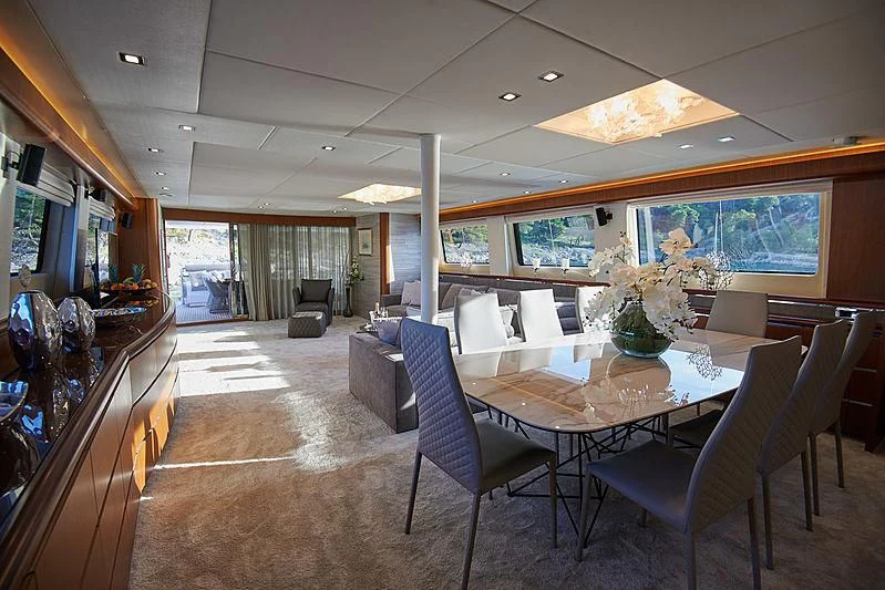 a room with a table chairs and a television aboard PRINCESS LONA Yacht for Sale