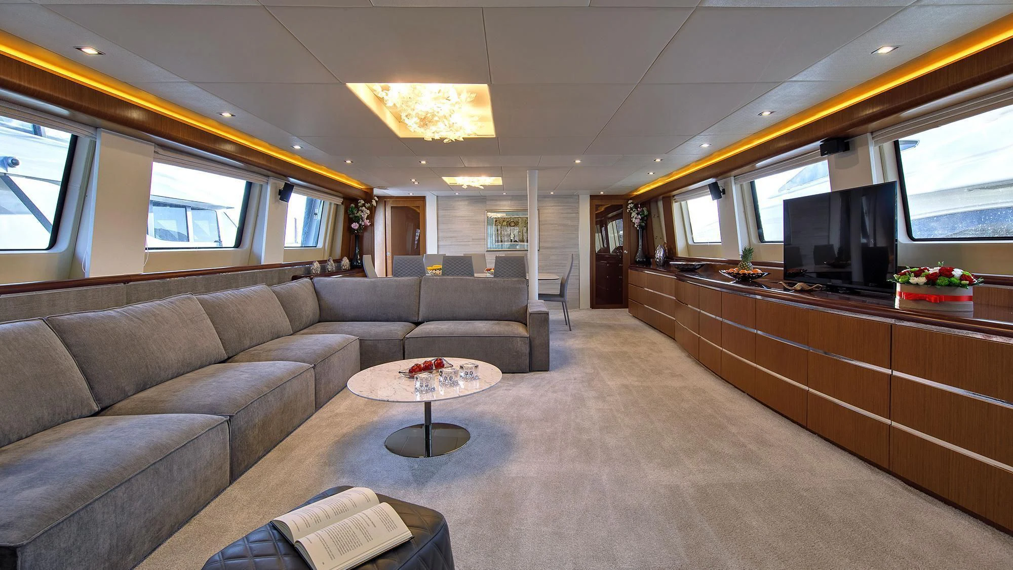 a living room with a couch and a television aboard PRINCESS LONA Yacht for Sale