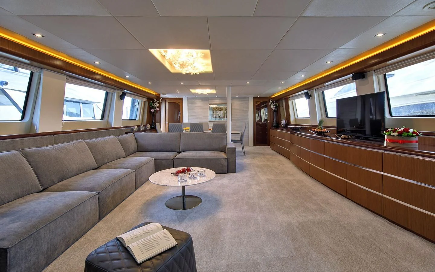 a living room with a couch and a tv aboard PRINCESS LONA Yacht for Sale