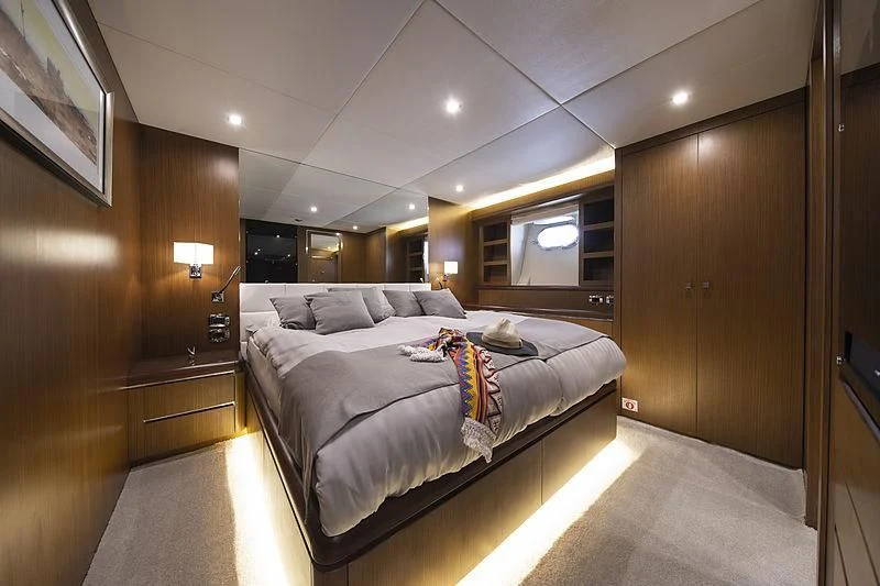 a bedroom with a bed and a mirror aboard PRINCESS LONA Yacht for Sale