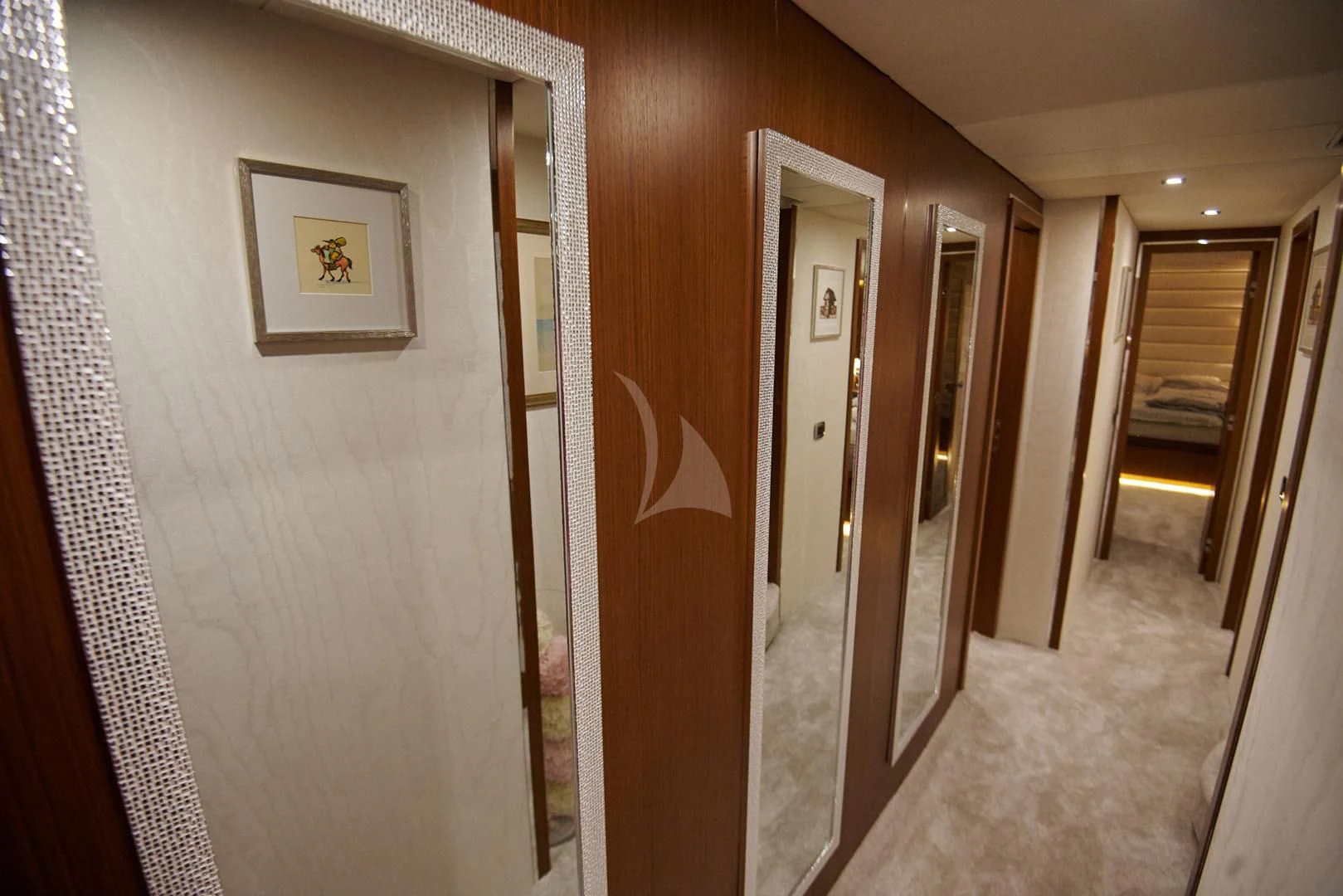 a hallway with a door and a wall with a painting on it aboard PRINCESS LONA Yacht for Sale