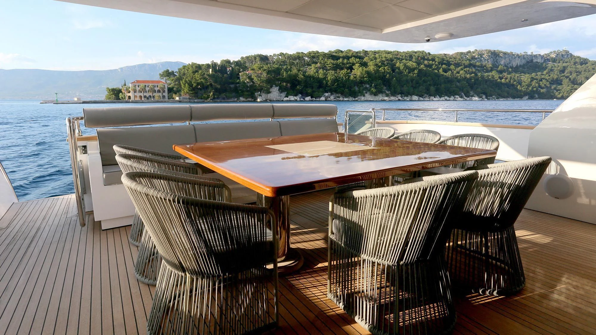 a table and chairs on a deck overlooking a body of water aboard PRINCESS LONA Yacht for Sale