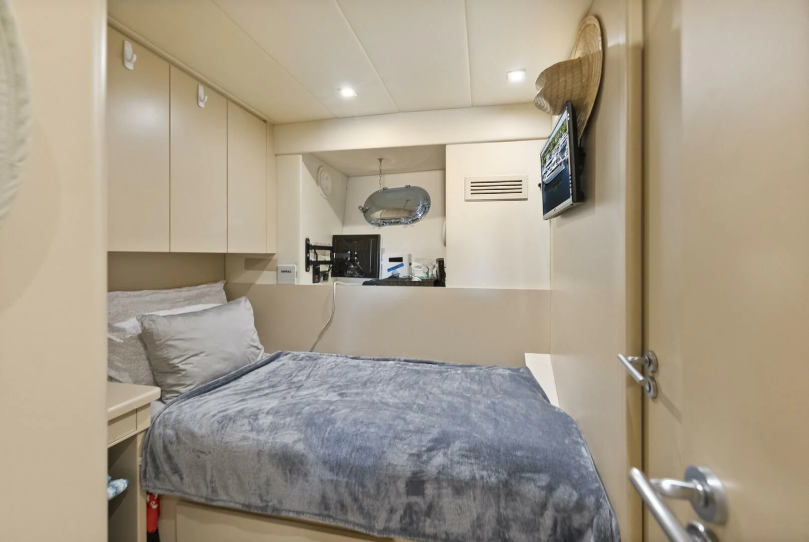 a bedroom with a bed and a television aboard PRINCESS LONA Yacht for Sale