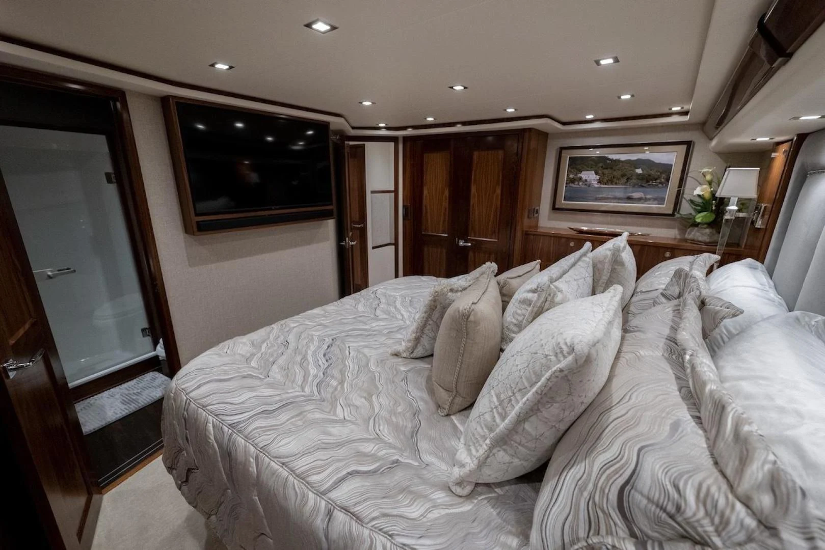 a bedroom with a bed and a television aboard GAME ON Yacht for Sale