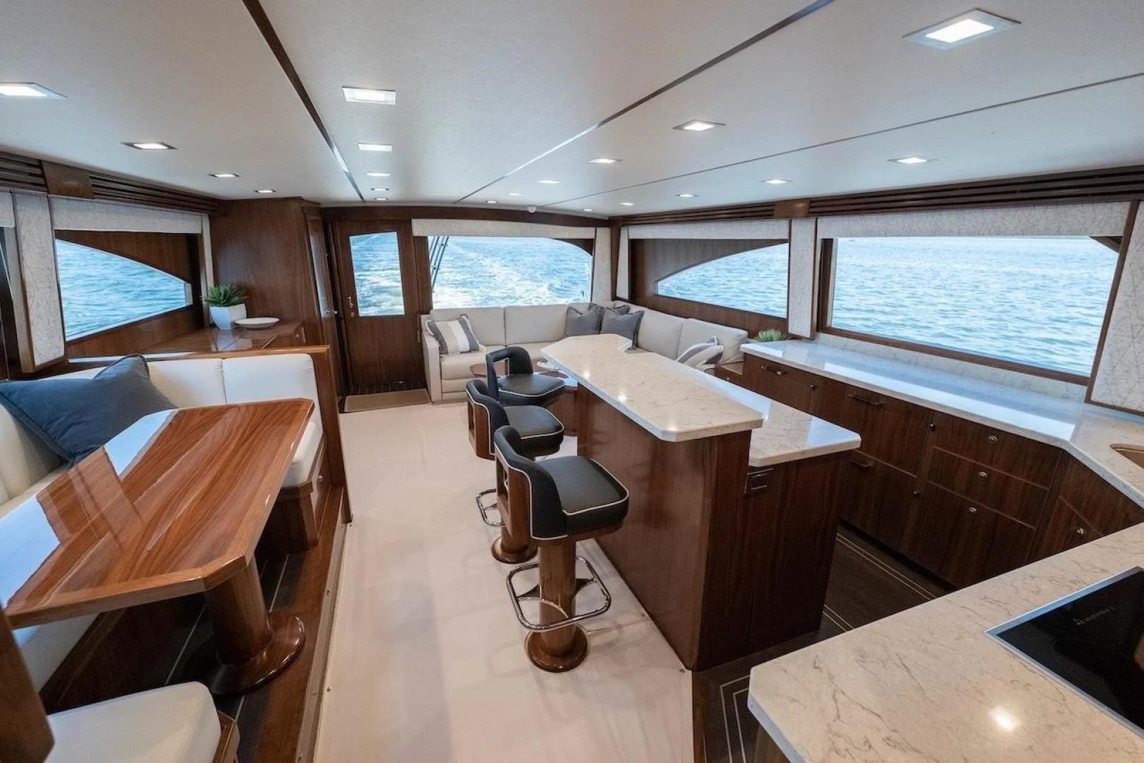 a room with tables and chairs aboard GAME ON Yacht for Sale